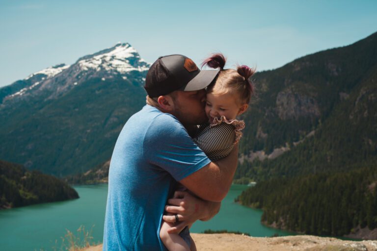 Man holding girl near mountains
