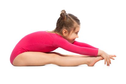 Cute little girl gymnast on a white background. Active lifestyle concept